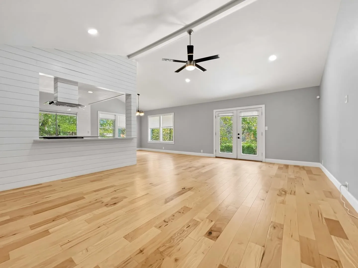 Empty living room with tall windows, ready to be staged
