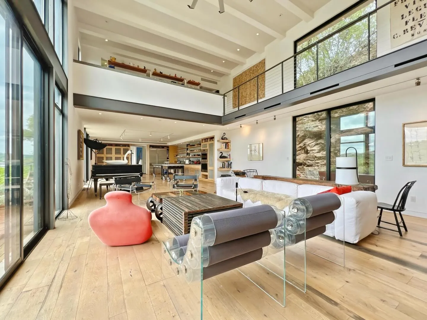 Bright double-height living room with lake views